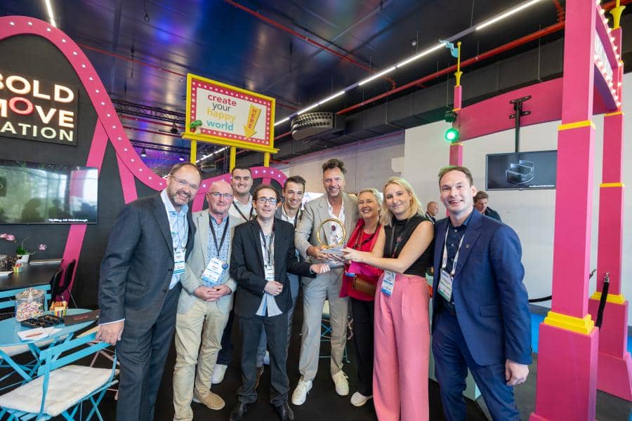 BoldMove team members pose with their Brass Ring Award in their booth.